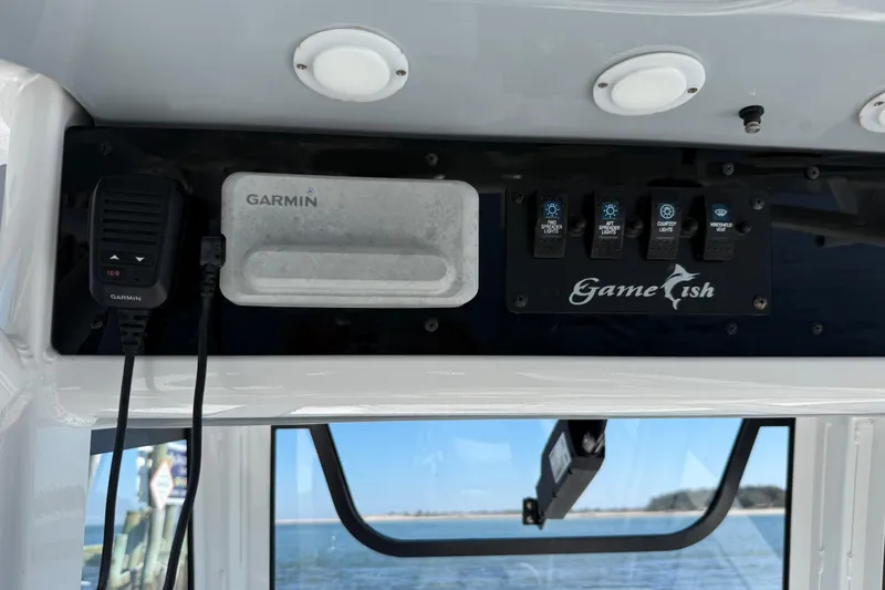 Slide: The Image of 2020 Sea Hunt Gamefish 27 dashboard with Garmin device and control panel. - 12