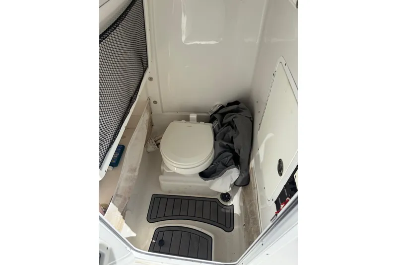 Slide: The Image of 2020 Sea Hunt Gamefish 27 boat interior with toilet and storage area. - 14