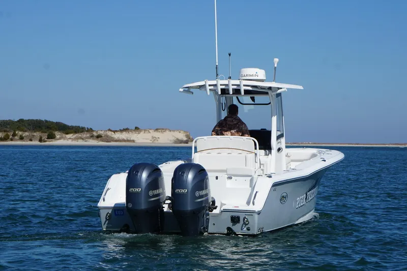 Slide: The Image of 2020 Sea Hunt Gamefish 27 boat with dual Yamaha engines on open water. - 3