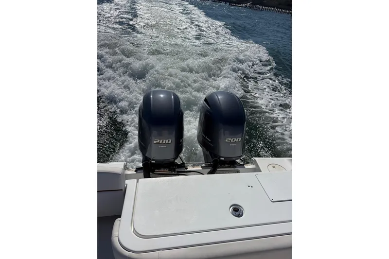Slide: The Image of Twin Yamaha 200 engines on a 2020 Sea Hunt Gamefish 27, cruising through water. - 4