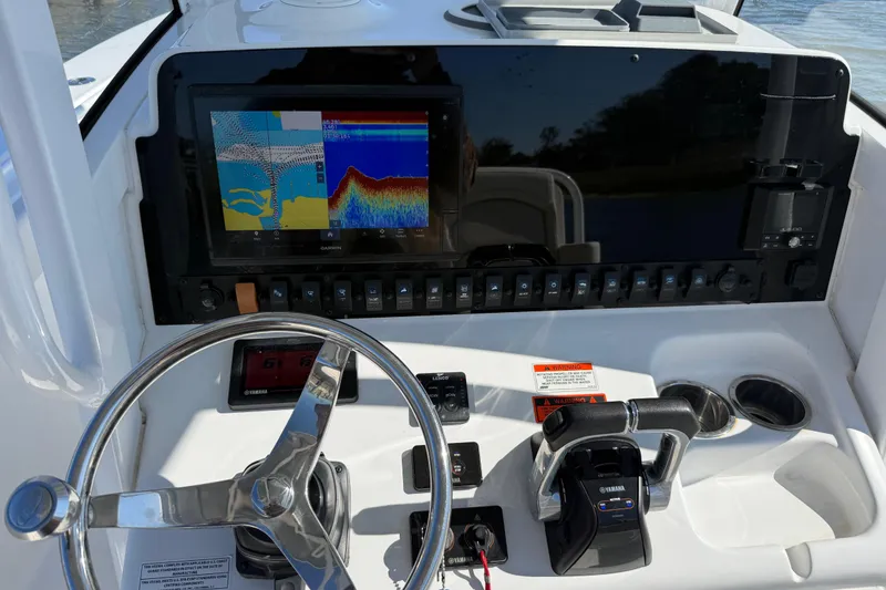 Slide: The Image of 2020 Sea Hunt Gamefish 27 dashboard with Garmin display and Yamaha controls. - 7
