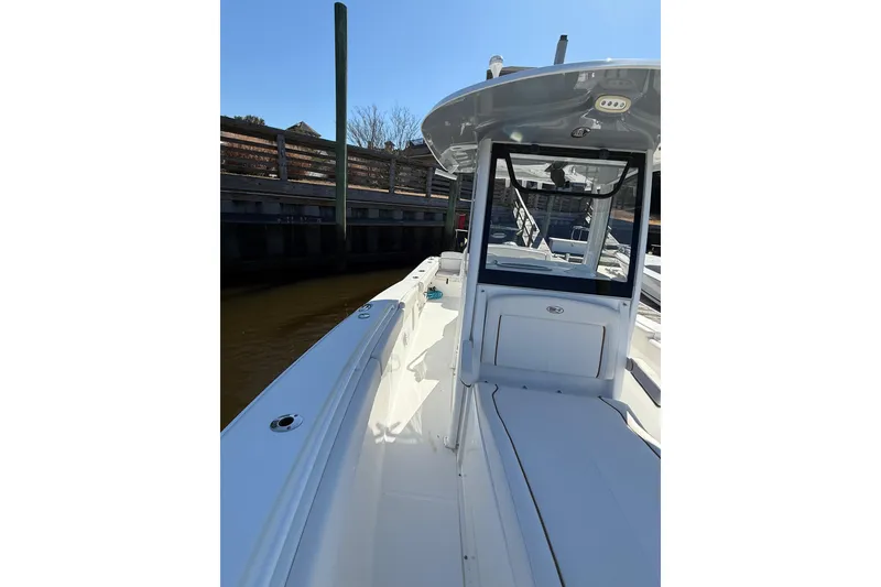 Slide: The Image of 2020 Sea Hunt Gamefish 27 boat docked, showcasing sleek design and spacious deck. - 8
