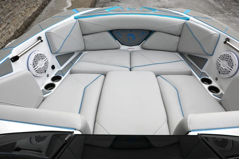 Slide: The Image of 2026 Centurion Nv233 boat interior with sleek gray seating and blue accents. - 10