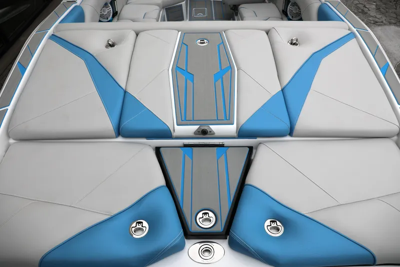Slide: The Image of 2026 Centurion Nv233 boat interior with blue and gray cushioned seating. - 22