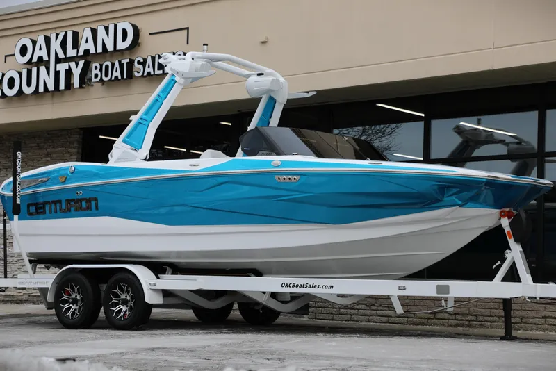 Slide: The Image of 2026 Centurion Nv233 boat in blue and white on trailer at Oakland County Boat Sales. - 24