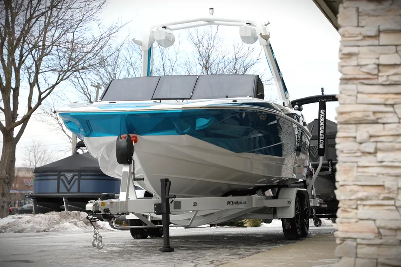 Slide: The Image of 2026 Centurion Nv233 boat on trailer, parked outdoors in winter setting. - 25