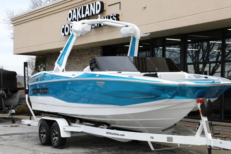 Slide: The Image of 2026 Centurion Nv233 boat in blue and white on a trailer outside Oakland dealership. - 26
