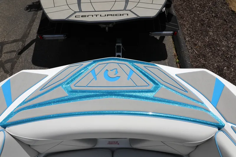 Slide: The Image of 2026 Centurion Nv233 boat with blue and gray detailing, viewed from above. - 11