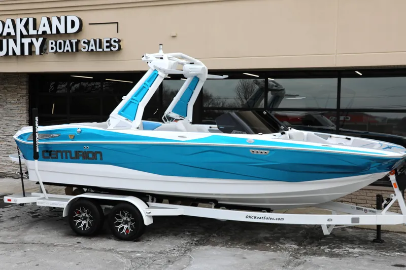 Slide: The Image of 2026 Centurion Nv233 boat in blue on trailer at Oakland County Boat Sales. - 8