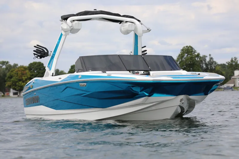 Slide: The Image of 2026 Centurion Nv233 boat on water, featuring sleek blue and white design. - 4