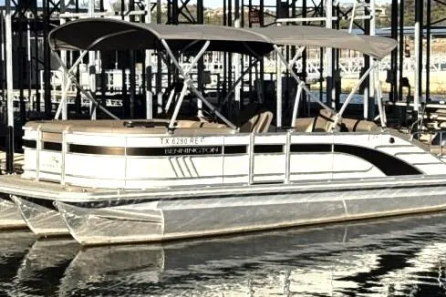 Slide: The Image of 2021 Bennington L 24 Swingback pontoon boat docked in marina. - 1