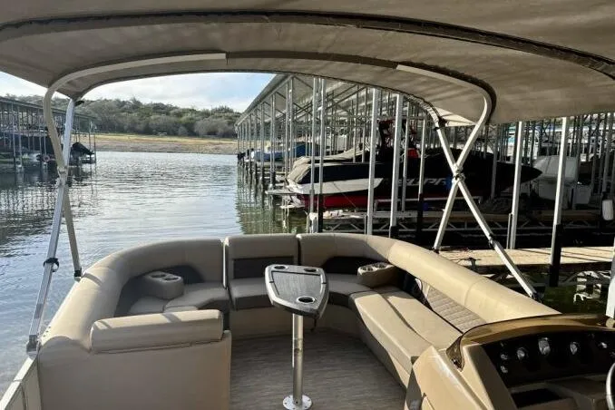 Slide: The Image of 2021 Bennington L 24 Swingback pontoon boat interior at marina dock. - 10