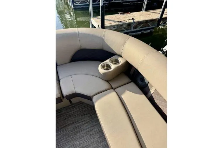 Slide: The Image of 2021 Bennington L 24 Swingback boat interior with beige seating and cup holders. - 17