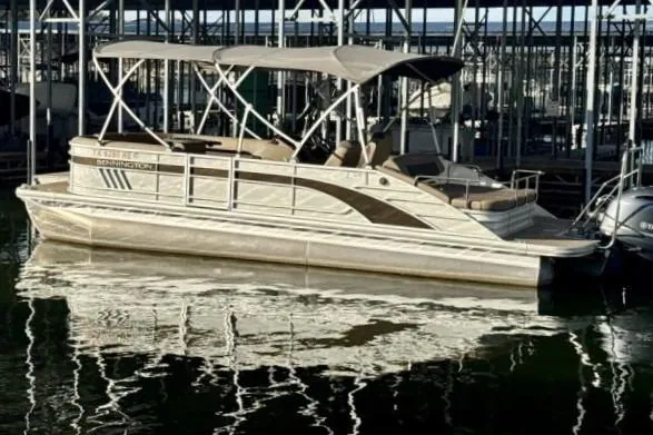Slide: The Image of 2021 Bennington L 24 Swingback pontoon boat docked in marina, reflecting on water. - 23