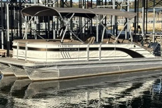 Slide: The Image of 2021 Bennington L 24 Swingback pontoon boat docked on calm water. - 26