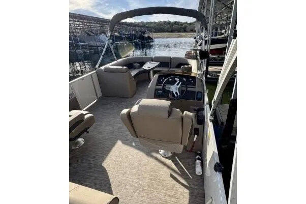 Slide: The Image of 2021 Bennington L 24 Swingback pontoon boat interior with seating and steering console. - 3
