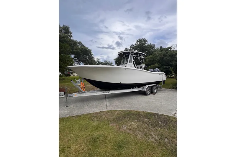 Slide: The Image of 2021 Tidewater 272 CC Adventure boat on trailer, parked outdoors. - 10