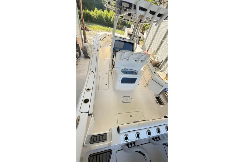 Slide: The Image of 2021 Tidewater 272 CC Adventure boat interior with helm and seating area. - 5