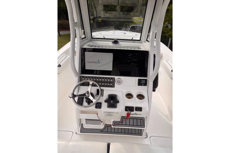 Slide: The Image of 2021 Tidewater 272 CC Adventure boat console with Garmin display and steering wheel. - 9