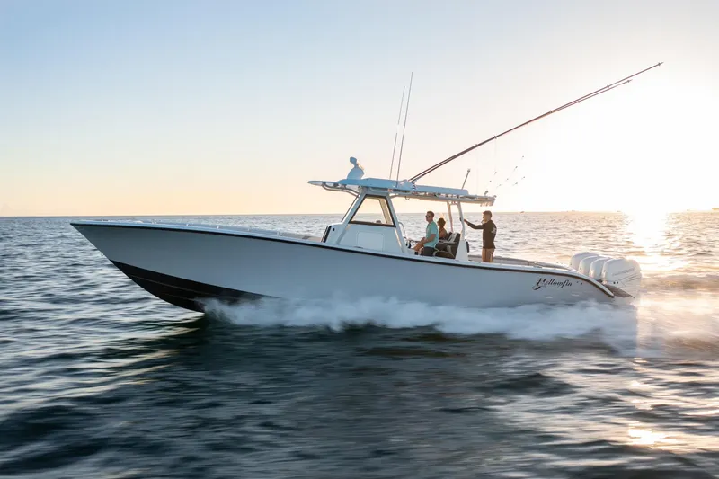 Slide: The Image of 2019 Yellowfin 39 boat cruising on open water at sunset. - 11