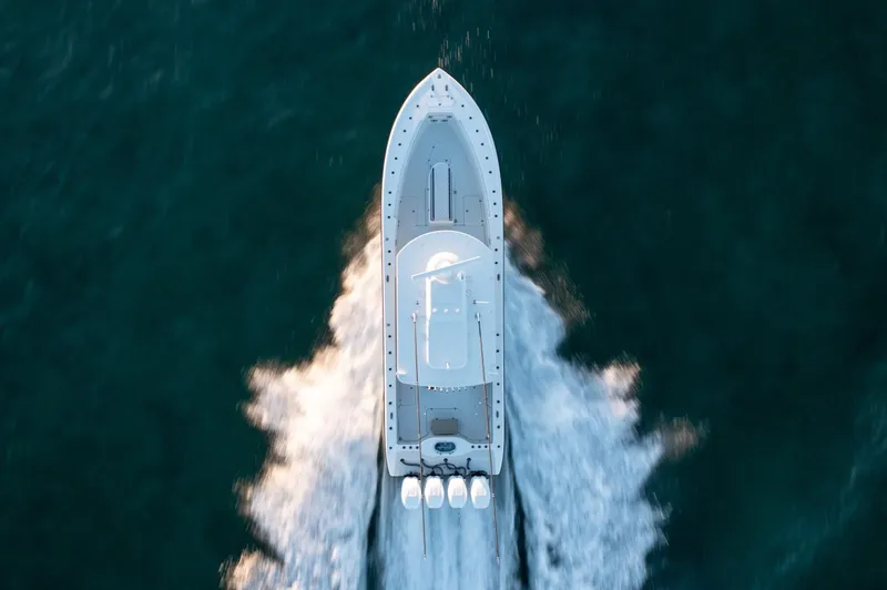 Slide: The Image of Aerial view of a 2019 Yellowfin 39 boat speeding on water. - 18