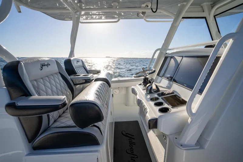 Slide: The Image of 2019 Yellowfin 39 boat interior with luxurious seating and modern dashboard, ocean view. - 20