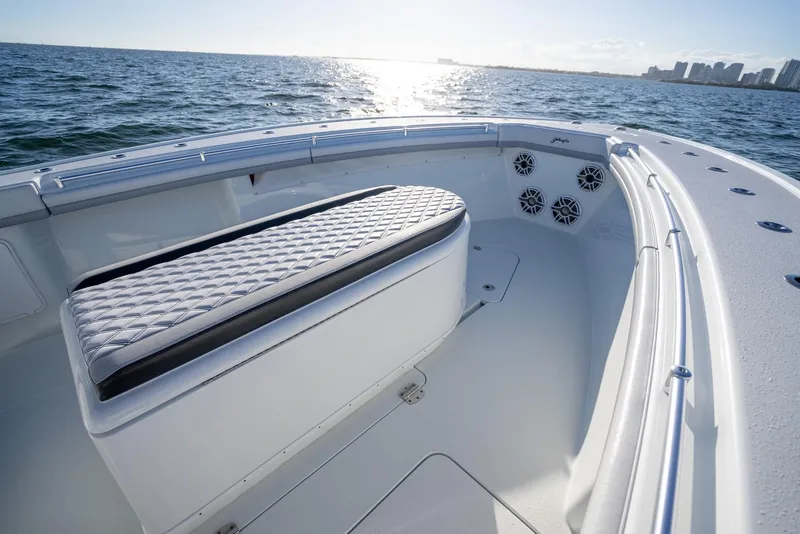 Slide: The Image of 2019 Yellowfin 39 boat interior with cushioned seating and ocean view. - 31
