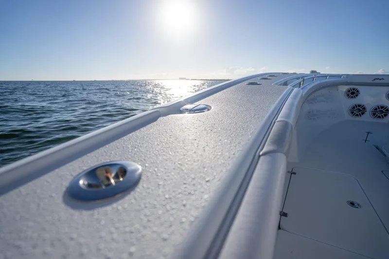 Slide: The Image of 2019 Yellowfin 39 boat on calm ocean waters under a bright sun. - 38