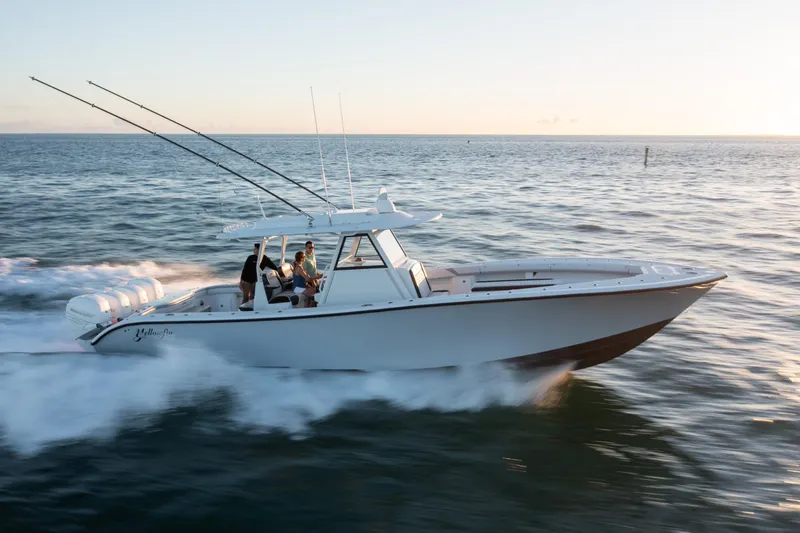 Slide: The Image of 2019 Yellowfin 39 boat cruising on open water at sunset. - 9