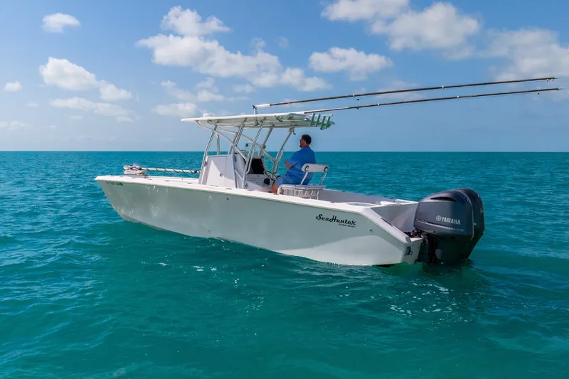 Slide: The Image of 2012 SeaHunter 29 boat on clear blue ocean with Yamaha engine. - 11