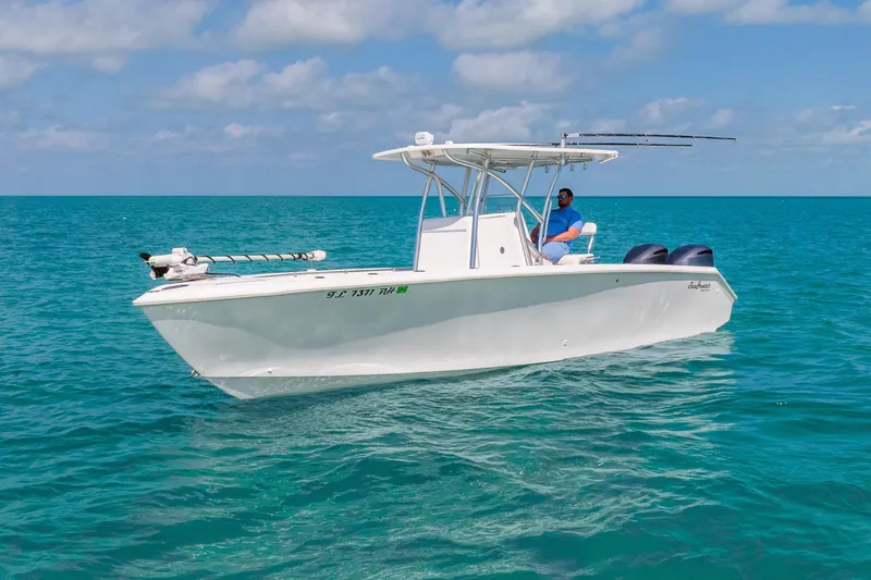 Slide: The Image of 2012 SeaHunter 29 boat on clear blue ocean, sunny day, person onboard. - 14