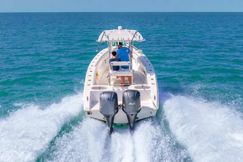 Slide: The Image of 2012 SeaHunter 29 boat cruising on open ocean with twin engines. - 17