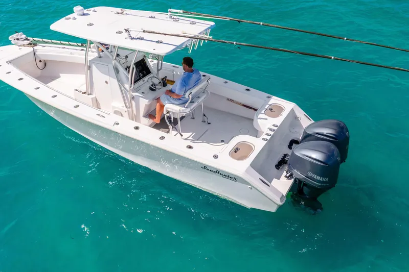Slide: The Image of 2012 SeaHunter 29 boat with dual Yamaha engines on clear turquoise water. - 18