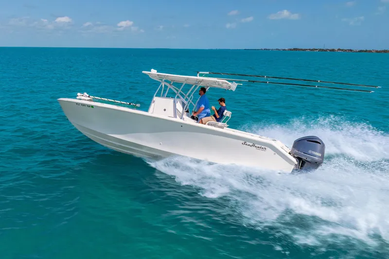 Slide: The Image of 2012 SeaHunter 29 boat cruising on clear blue ocean waters. - 3