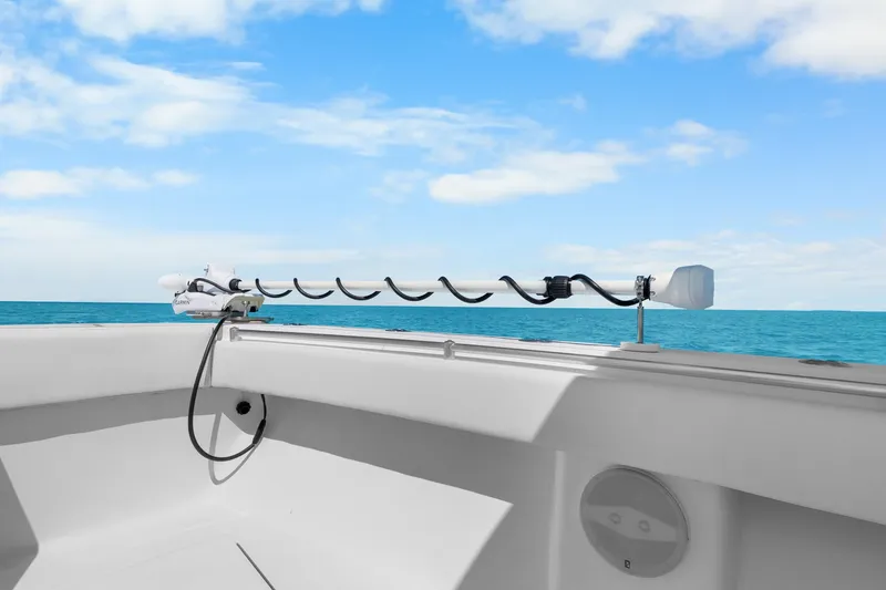 Slide: The Image of 2012 SeaHunter 29 boat with trolling motor, ocean view, and clear blue sky. - 31