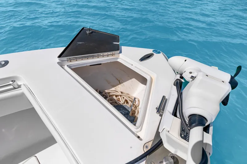Slide: The Image of Open storage compartment on 2012 SeaHunter 29 boat, with rope, against clear blue water. - 36