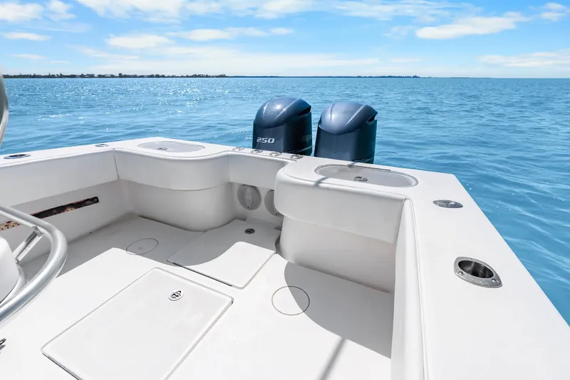 Slide: The Image of 2012 SeaHunter 29 boat with dual engines on calm blue water. - 37