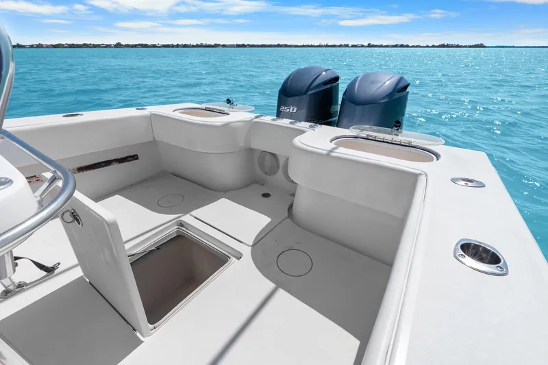 Slide: The Image of 2012 SeaHunter 29 boat with dual engines on clear blue water. - 38