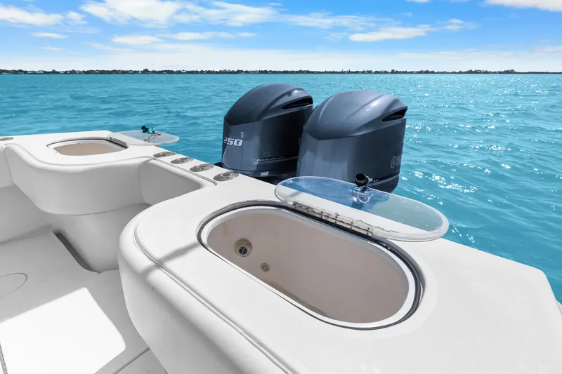 Slide: The Image of 2012 SeaHunter 29 boat with dual outboard engines on clear blue water. - 39
