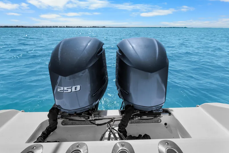 Slide: The Image of Twin 250 horsepower outboard motors on a 2012 SeaHunter 29 boat, ocean view. - 40