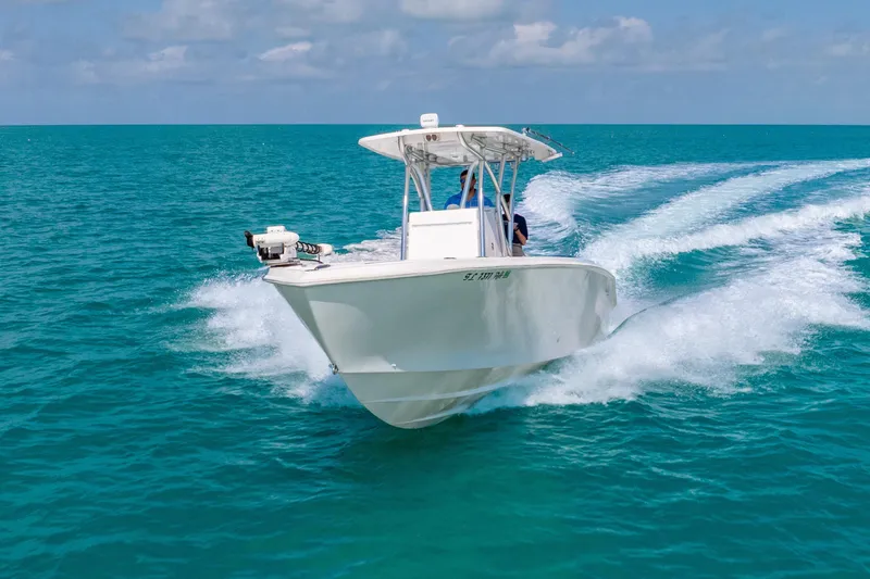 Slide: The Image of 2012 SeaHunter 29 boat cruising on clear blue ocean waters. - 6