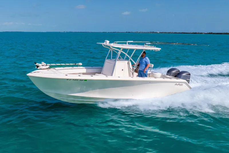 Slide: The Image of 2012 SeaHunter 29 boat cruising on clear blue ocean waters. - 7