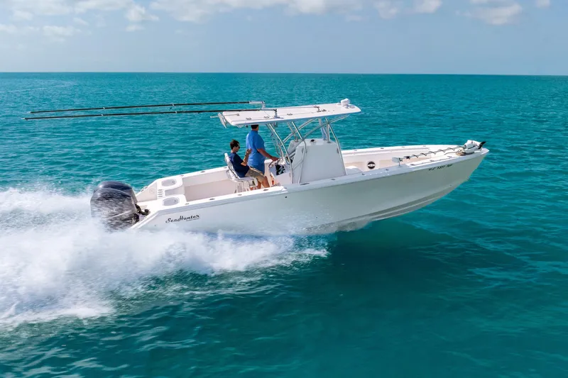 Slide: The Image of 2012 SeaHunter 29 boat cruising on clear blue ocean waters. - 8