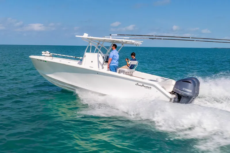 Slide: The Image of 2012 SeaHunter 29 boat cruising on open water with Yamaha engine. - 9