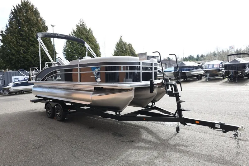Slide: The Image of 2026 Harris Cruiser 210 SL pontoon boat on trailer in outdoor lot. - 10