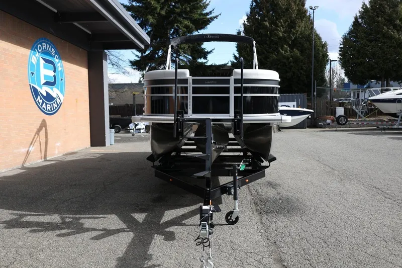 Slide: The Image of 2026 Harris Cruiser 210 SL pontoon boat on trailer at Bjornson Marine dealership. - 13