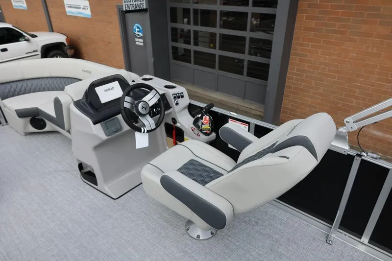 Slide: The Image of 2026 Harris Cruiser 210 SL boat interior with steering console and captain's chair. - 23