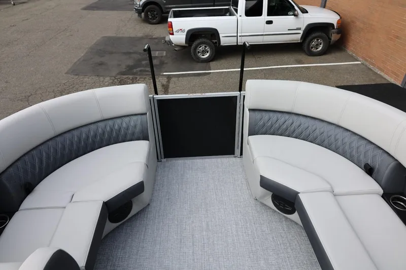 Slide: The Image of 2026 Harris Cruiser 210 SL boat interior with gray seating and diamond stitching. - 25