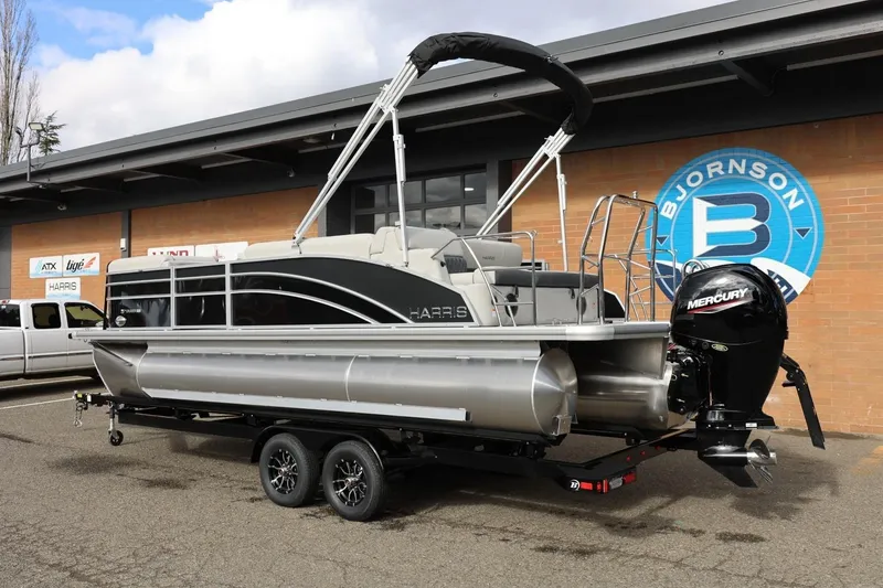 Slide: The Image of 2026 Harris Cruiser 210 SL pontoon boat on trailer, displayed outside dealership. - 3