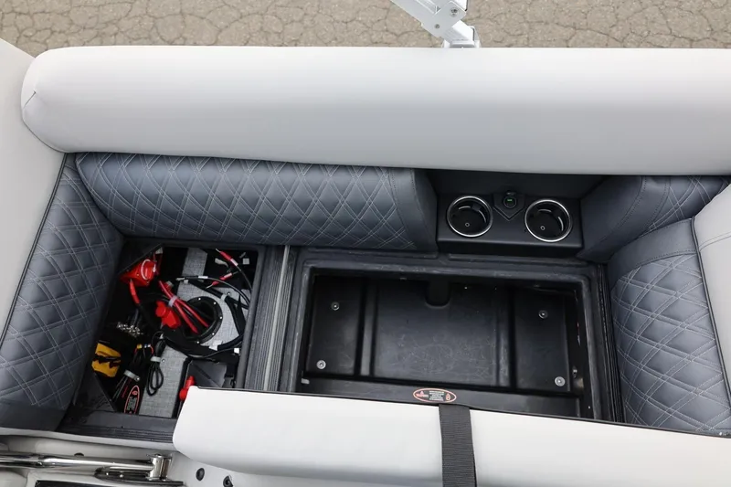 Slide: The Image of 2026 Harris Cruiser 210 SL boat interior with storage compartment and cup holders. - 35